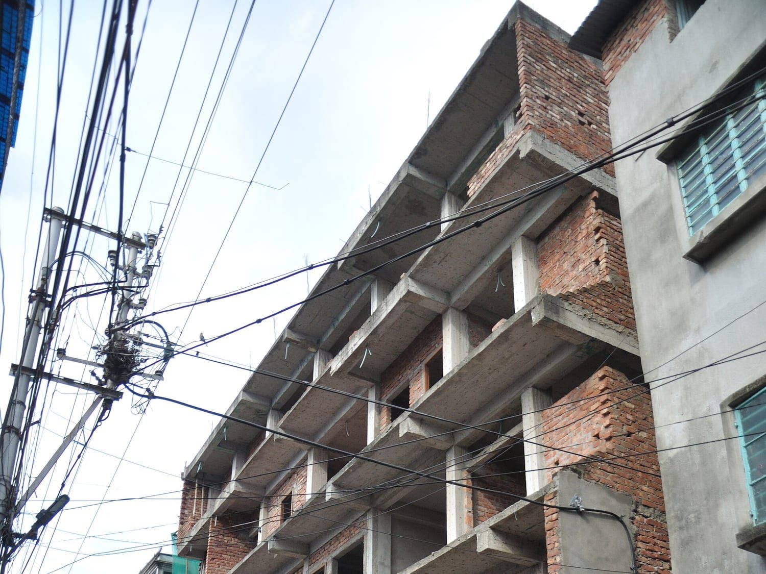 Concrete frame of a residential building under construction, cast to roof level. Stand-in photograph.